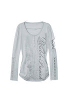 Long sleeve Henley top in mist blue from the Double Punch SS26 'Illusory Glory' collection featuring a distressed graphic print, silver-tone buttons, a cutout sleeve, and studded forearm panels.